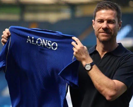 Xabi Alonso poses with a Chelsea shirt with his name printed on the back at Stamford Bridge