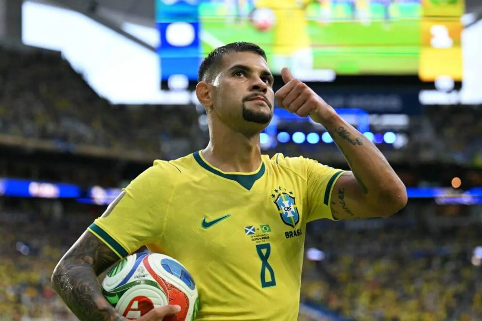 Bruno Guimaraes giving a thumbs up while playing for Brazil
