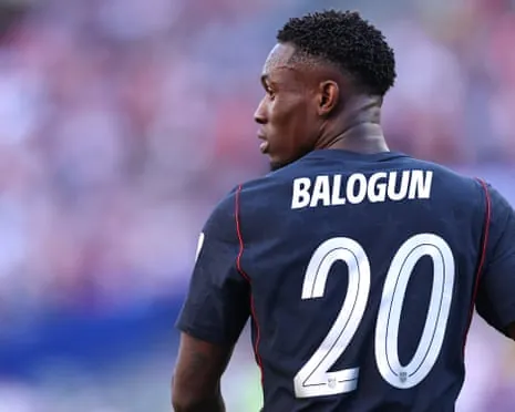 Folarin Balogun wearing a dark blue jersey with his name and number 20 on the back